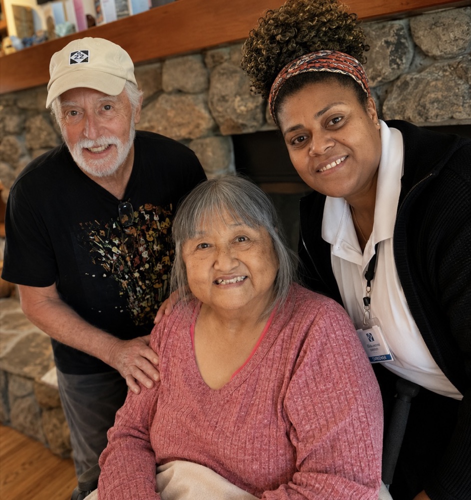 A Providential Fijian Home Care caregiver with a client and her family in Windsor